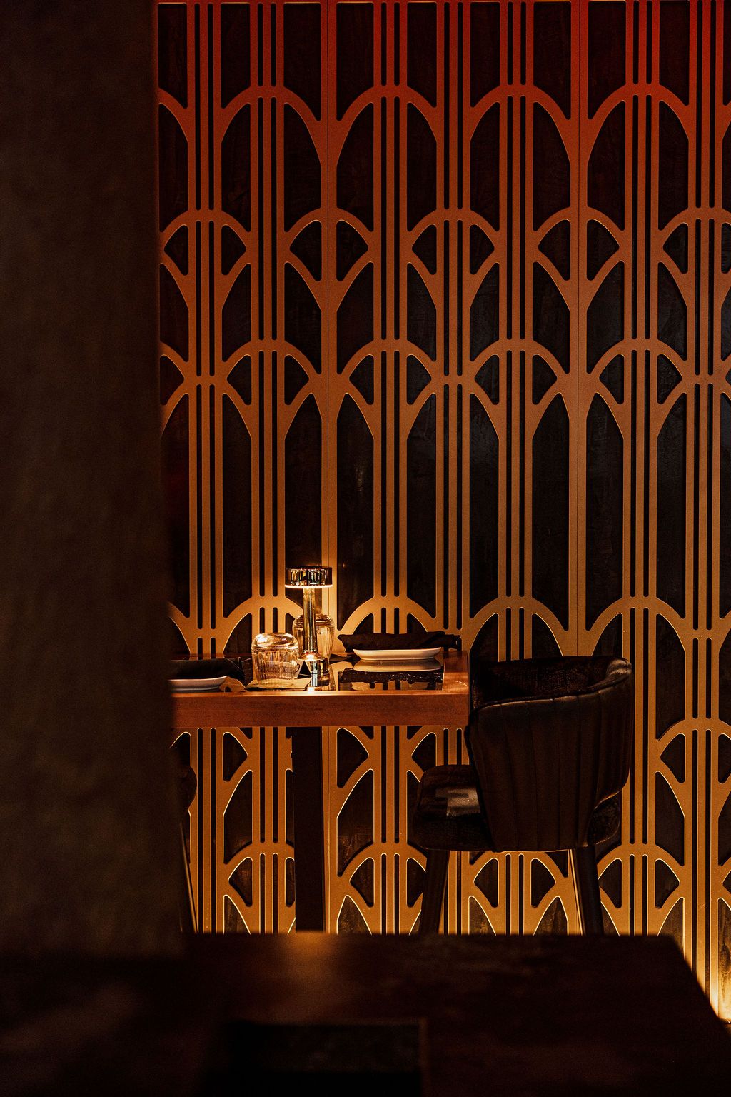 A table for two behind the gold lattice at Casa 73